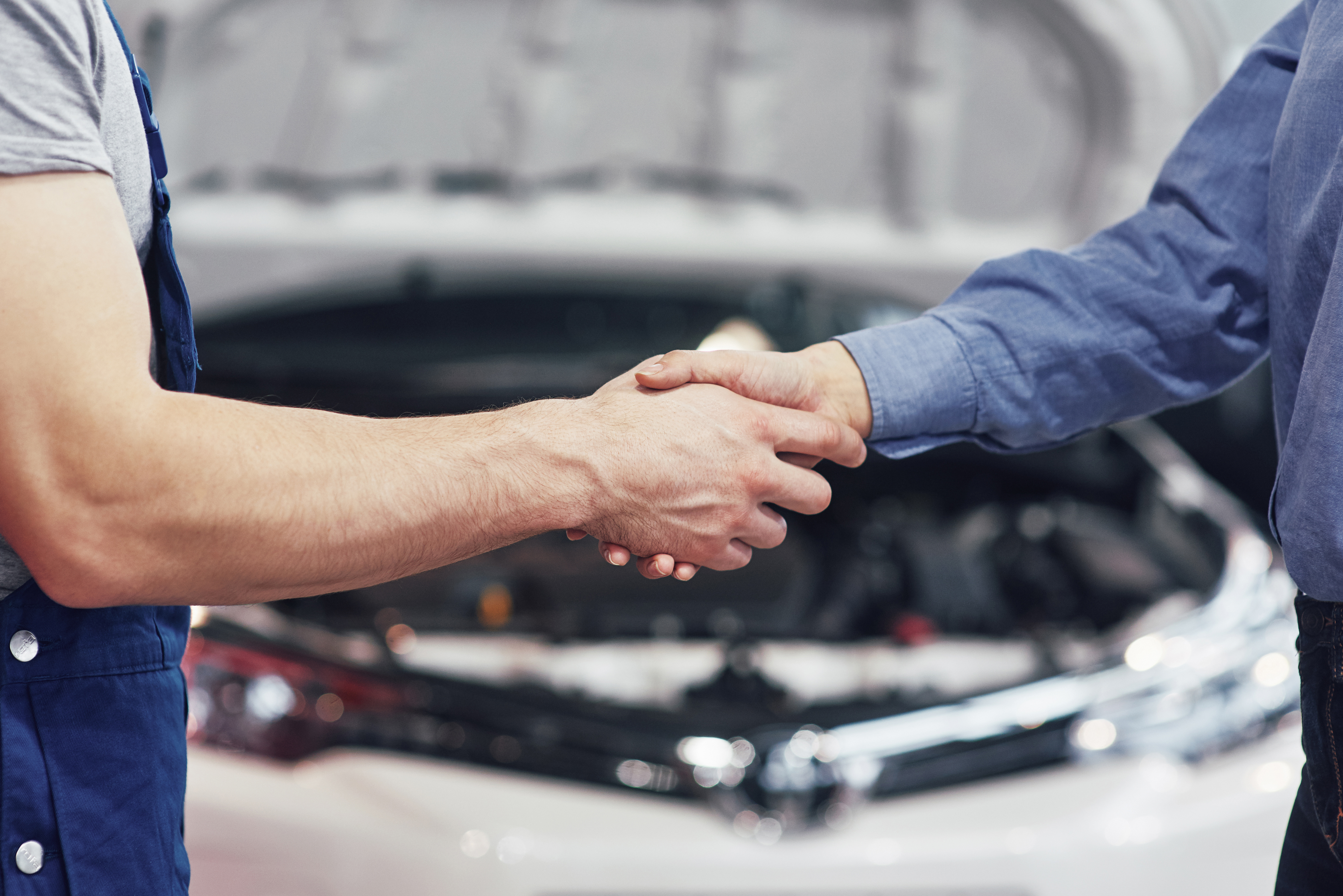 husband car mechanic and woman customer make an agreement on the repair of the car.
